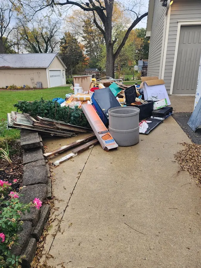 Dumpster being loaded with debris for Roofing Dumpster Rental in Warsaw